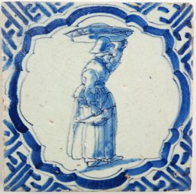 Antique Delft tile with a woman carrying goods, 17th century