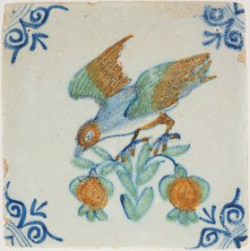 Antique Delft tile with a bird chasing two pieces of fruit, 17th century