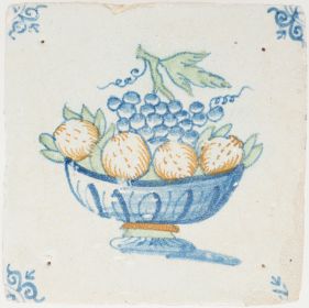 Antique Delft tile with grapes and oranges in a fruit bowl, 17th century