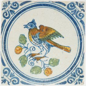 Antique Delft tile with bird on fruiting branch, 17th century
