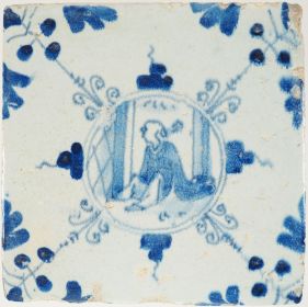 Antique Delft blue tile showing a seated Chinese figure with three-dot corner motifs, 17th century