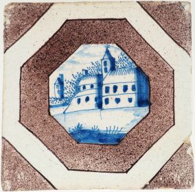 Antique Delft wall tile with a stronghold in blue within a manganese accolade border, 18th century