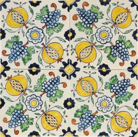 Hand-painted Delft tiles depicting pomegranates and grapes in a ornamental pattern. 