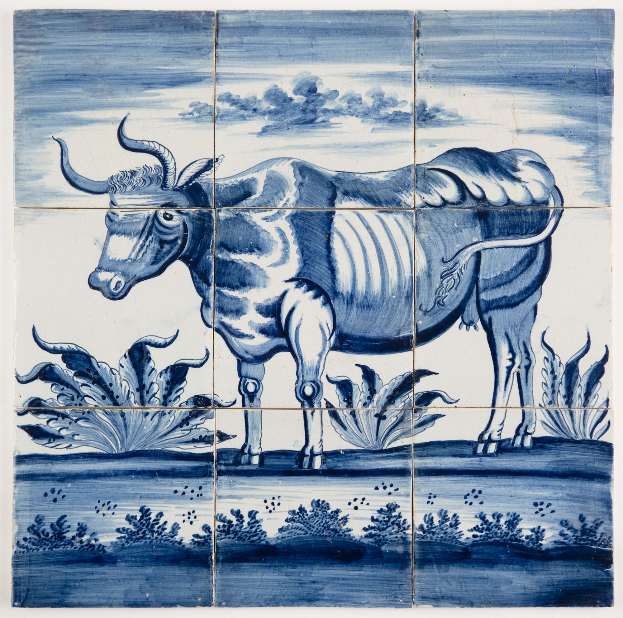 Antique Delft tile mural with a cow in blue based on an engraving