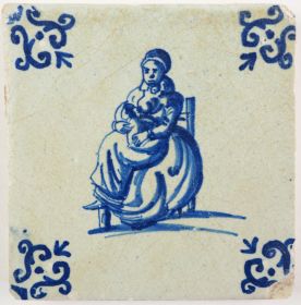 Antique Delft tile with a woman breastfeeding her child, 17th century