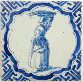 Antique Delft tile with a woman carrying goods, 17th century