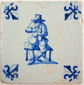 Antique Delft tile with a man slicing bread, 17th century