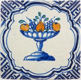 Antique Delft tile with a polychrome fruit bowl, 17th century