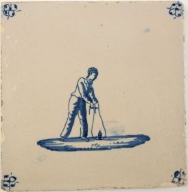 Antique Delft tile with a child playing with a spinning top, 19th century