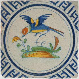 Antique polychrome Dutch Delft tile with a bird in flight, 17th century