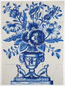 Antique Delft tile mural in blue with a richly decorated flower vase and two dogs at guard on the sides, 18th century