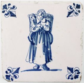 Antique Dutch Delft tile with a woman carrying goods, 17th century