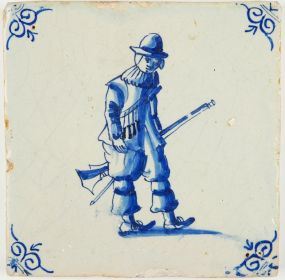 Antique Delft tile in blue with a soldier carrying his rifle, 17th century
