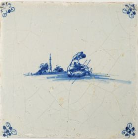 Antique Delft tile in blue with a man on a sledge, 17th century