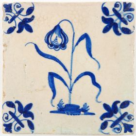 Antique Delft tile in blue with a flower and lily corner motifs, 17th century