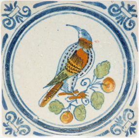 Antique Delft tile with bird on fruiting branch, 17th century