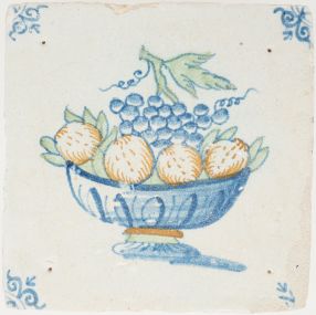 Antique Delft tile with grapes and oranges in a fruit bowl, 17th century