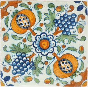 Antique Delft tile with polychrome pomegranates, grape clusters, and central rosette in ornament pattern, 17th century
