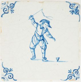Antique Delft tile with a child playing with a spinning top, 17th century