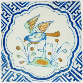 Antique Delft tile with a bird in flight, 17th century