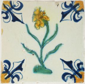 Antique Delft polychrome tile from Gouda with a flower in green and yellow, 17th century
