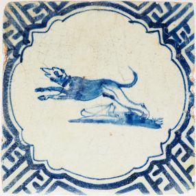 Antique Delft tile with a jumping dog in blue, 17th century
