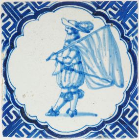 Antique Delft wall tile depicting a Dutch standard-bearer carrying a flag, 17th century