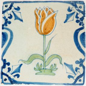 Antique Delft wall tile depicting a polychrome orange tulip with green leaves,17th century