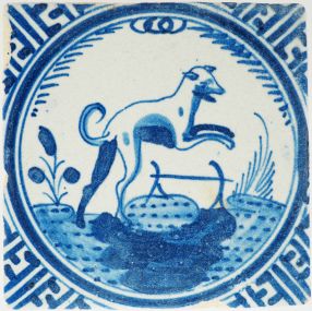 Antique 17th-century Delft crown tile depicting a jumping dog in blue, 17th century