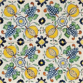 Hand-painted Delft tiles depicting pomegranates and grapes in a ornamental pattern. 