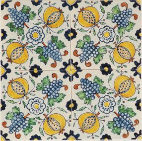 Hand-painted Delft tiles depicting pomegranates and grapes in a ornamental pattern.