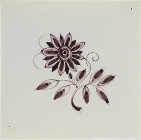 Hand-painted Delft tile sample with small flowers painted in manganese