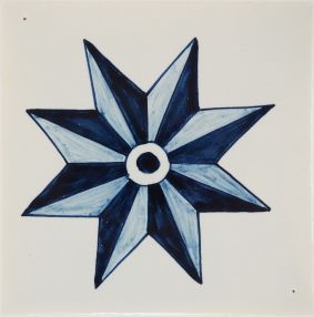 Hand-painted Delft tile sample with a star, painted in a classic Delft blue