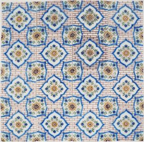 19th-century Delft wall tiles with wall flower pattern on brick background, repeating floral design