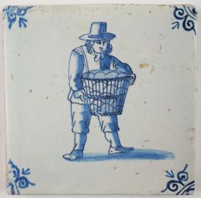 Antique Delft tile with a man carrying goods, 17th century