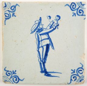 Antique Delft tile with a child blowing bubbles, 17th century