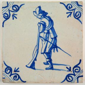 Antique Delft tile in blue with a musketeer loading his musket, 17th century