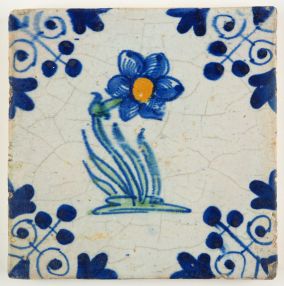 Antique Delft tile with a polychrome flower and the three-dot corner motif, 17th century