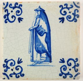 Antique Delft tile in blue with a woman wearing a huik, 17th century
