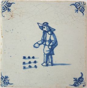 Antique Delft tile with a game of marbles, 17th century