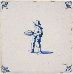 Antique Delft tile with a potter's assistant, 17th century