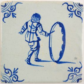 Antique Delft tile with a child playing with a hoop, 17th century