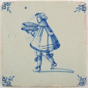 Antique Delft tile with a cook serving pastries, 17th century