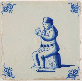 Antique Delft tile with a card player, 17th century