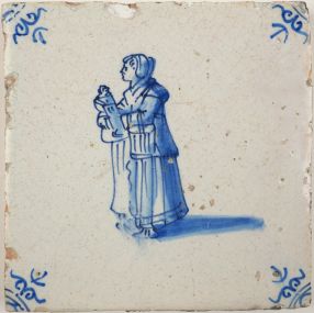 Antique Delft tile with girl with doll, 17th century