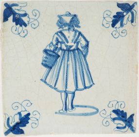 Antique Delft tile with a lady walking to the market, 17th century