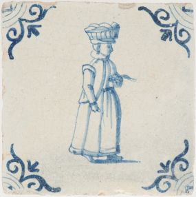 Antique Delft tile with a woman carrying goods, 17th century
