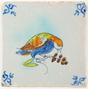 Antique Delft tile with a poychrome bird eating cherries, 17th century