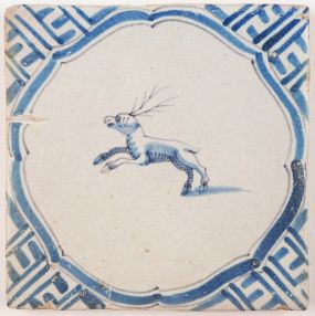Antique Delft tile in blue with a deer surrounded by a Wanli inspired corner motif, 17th century