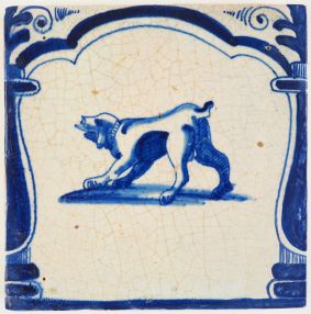 Antique Delft archway tile in blue with a playful dog, 17th century